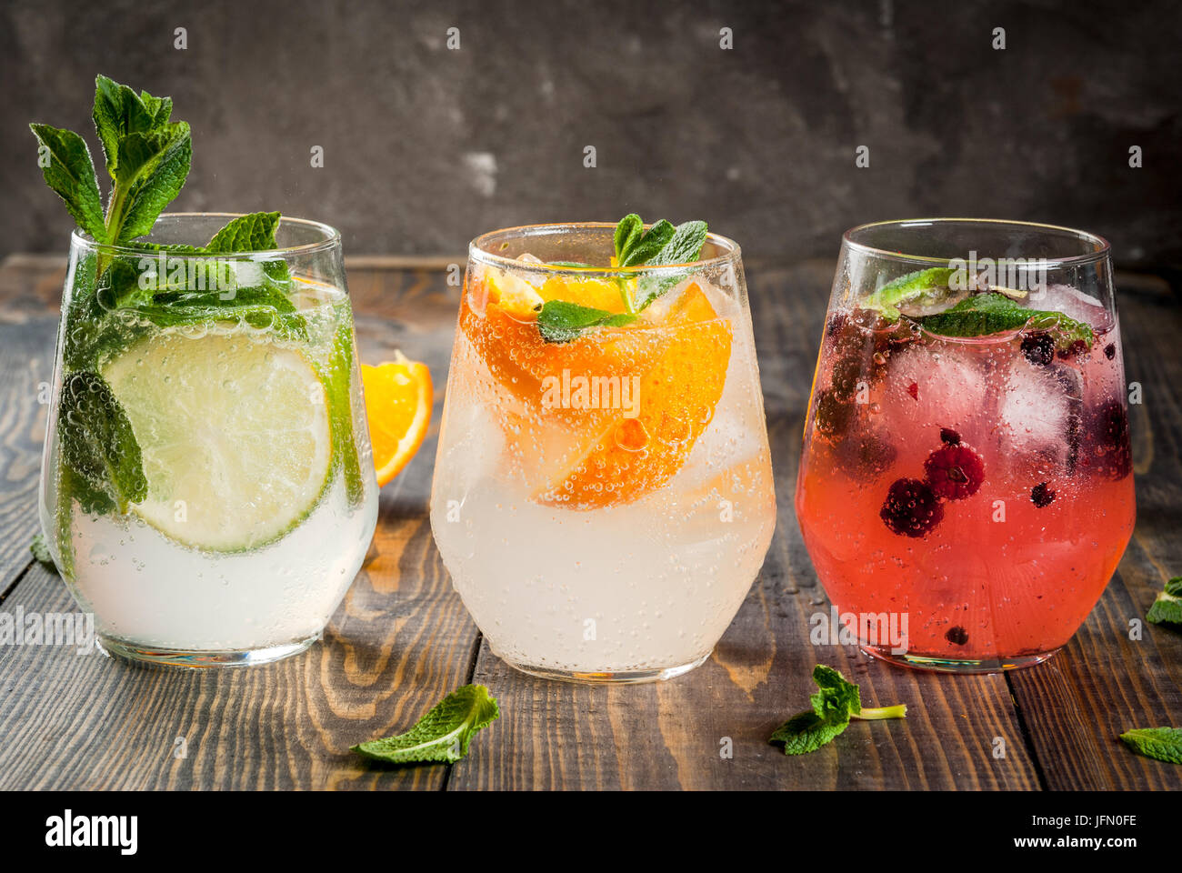 Selection of three kinds of gin tonic with blackberries, with orange