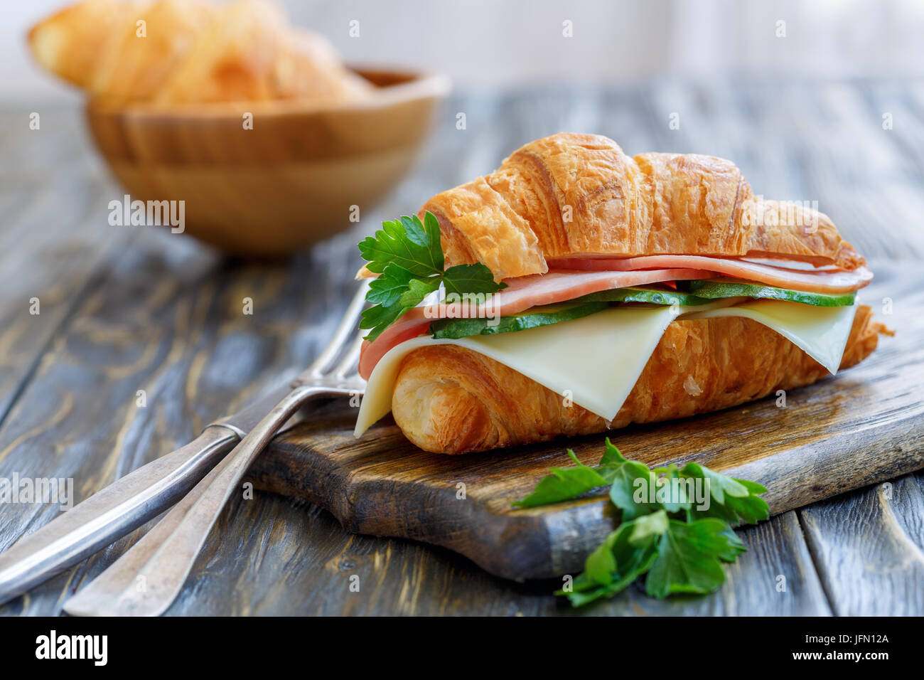 Croissant with cheese, ham and cucumber Stock Photo Alamy