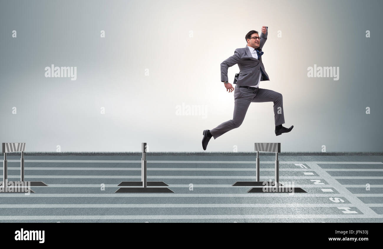 The businessman jumping over barriers in business concept Stock Photo
