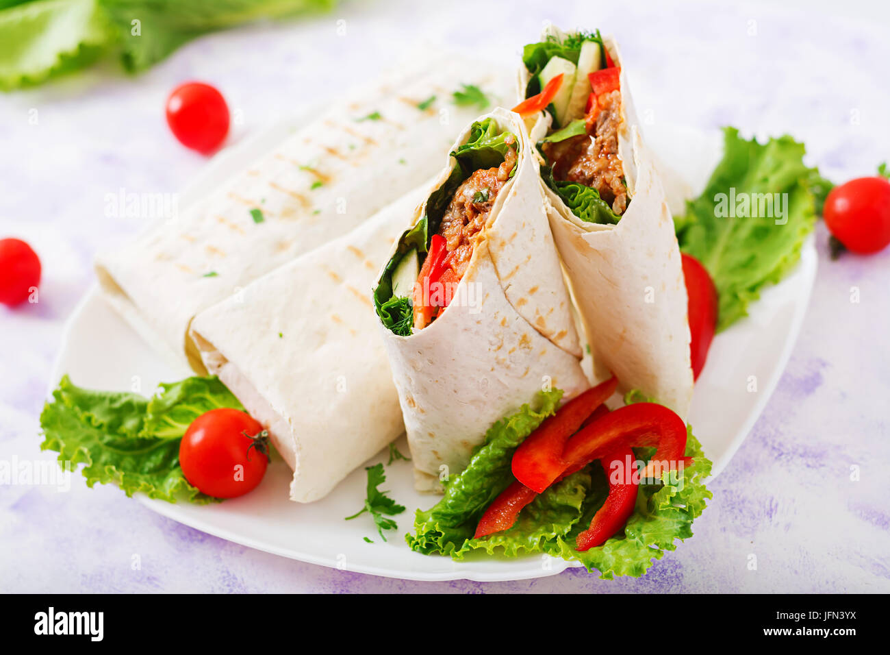 Burritos wraps with minced beef and vegetables on a light background Stock Photo Alamy