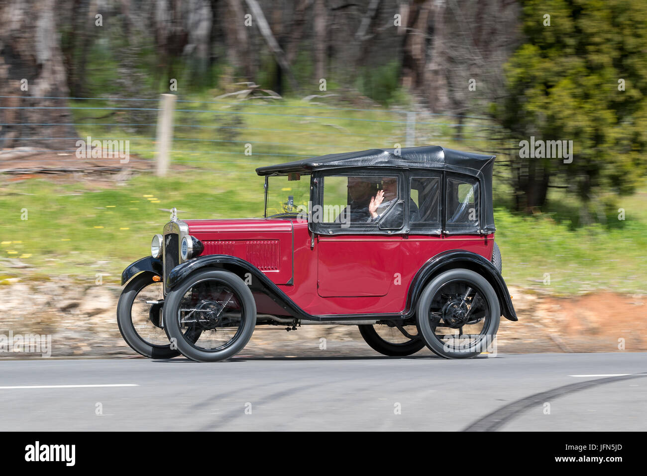Vintage 1930 Austin 7 Chummy Tourer driving on country roads near the town of Birdwood, South Australia. Stock Photo