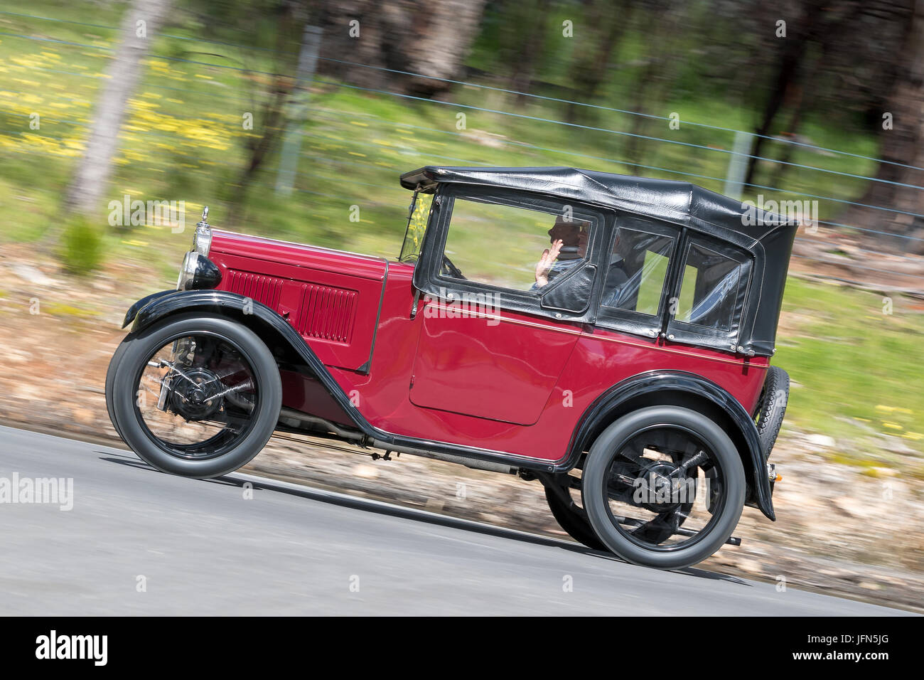 Vintage 1930 Austin 7 Chummy Tourer driving on country roads near the town of Birdwood, South Australia. Stock Photo