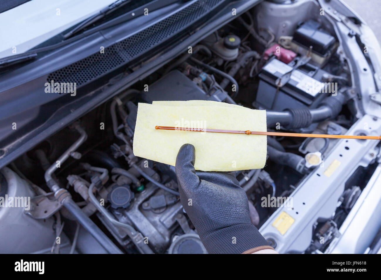 Checking motor oil level in the car. New engine lubricant Stock Photo