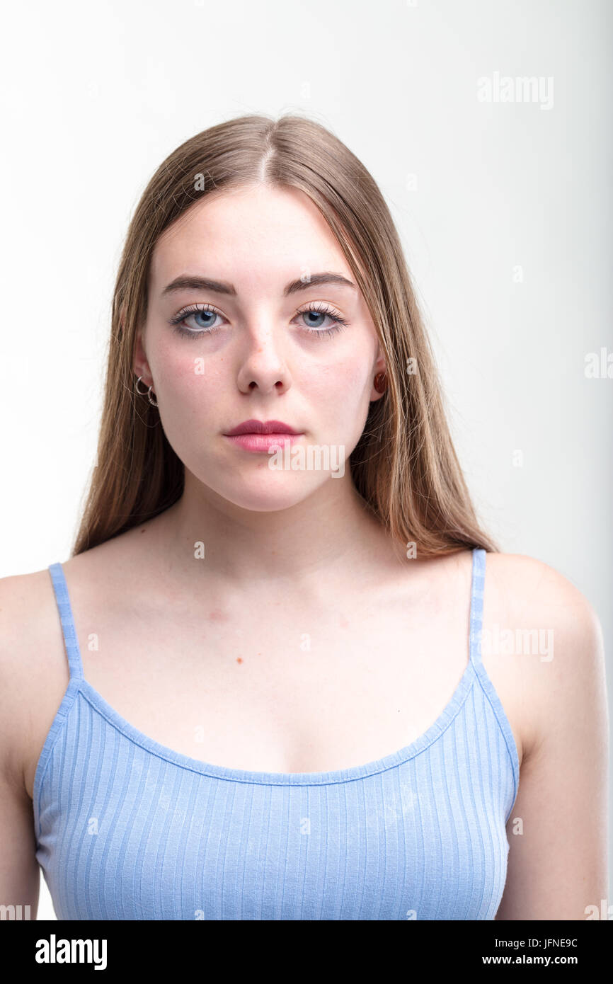 Young woman with a serious deadpan expression showing absolutely no