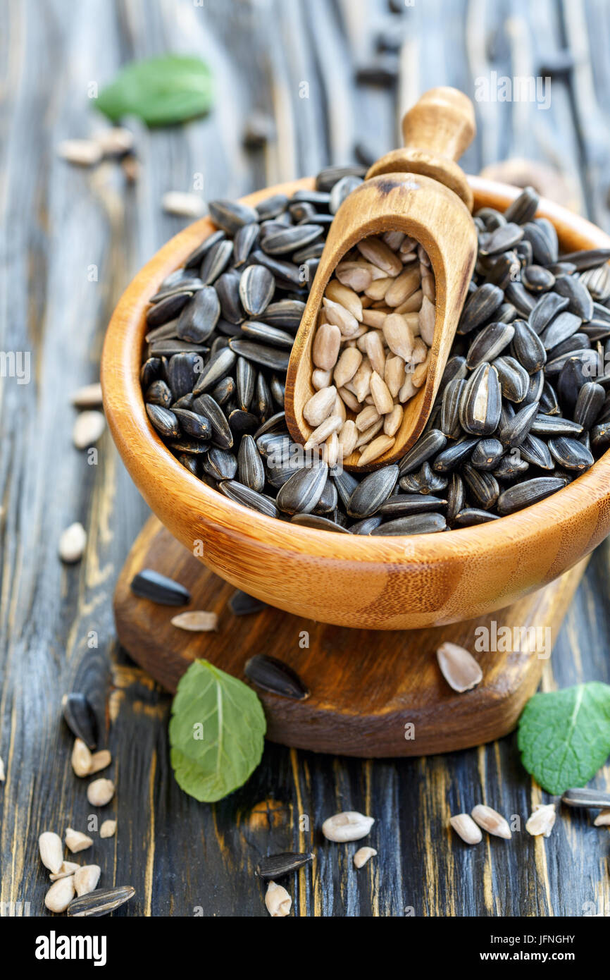 Wooden bowl with sunflower seeds and a scoop. Stock Photo