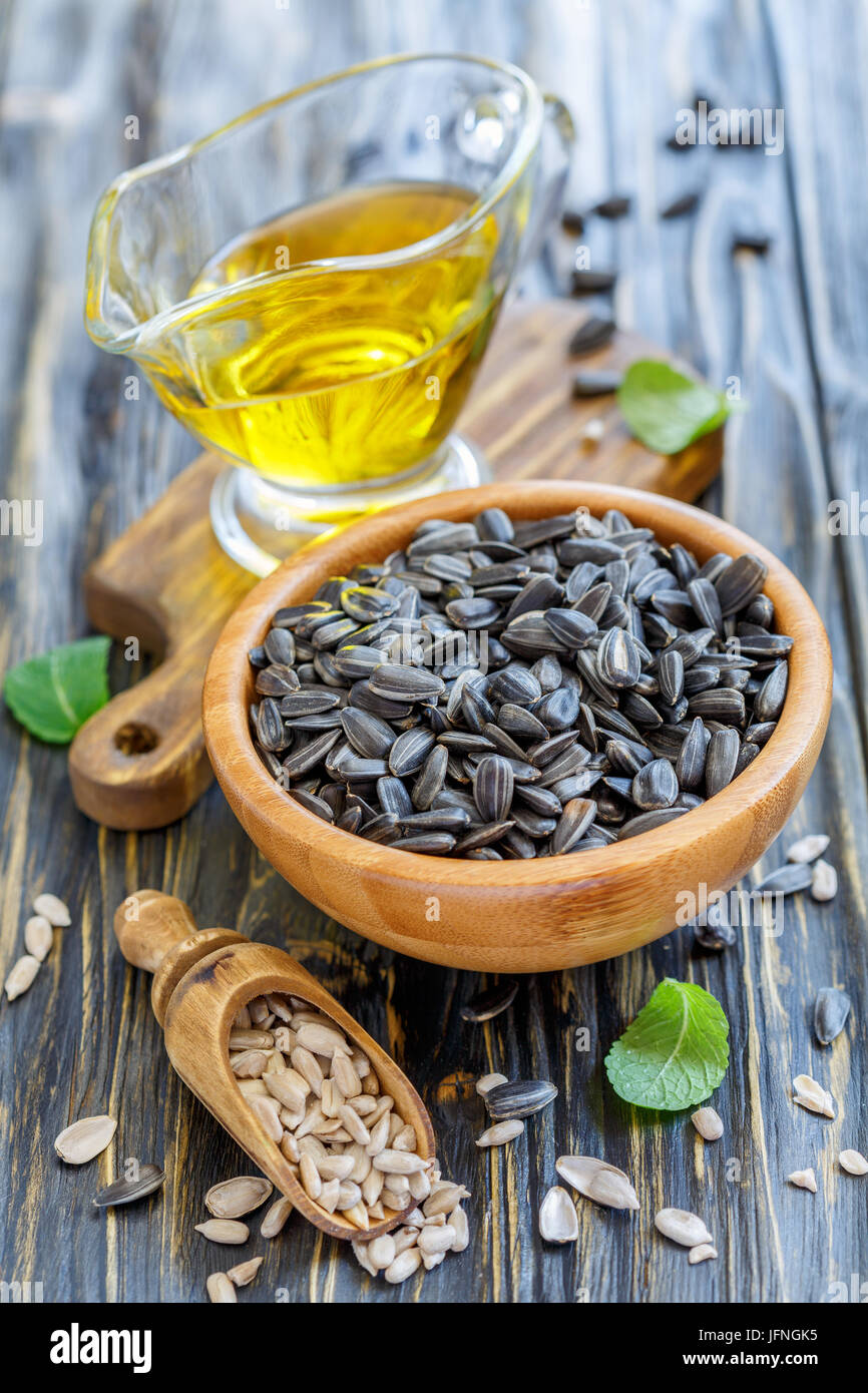 Sunflower seeds in bowl and oil into a glass cup. Stock Photo