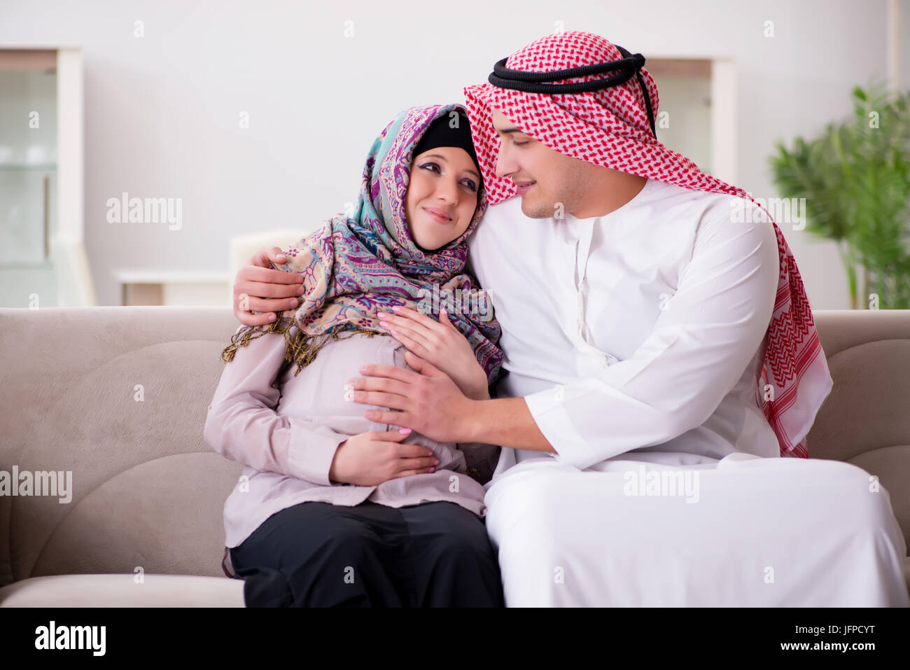 Young arab muslim family with pregnant wife expecting baby Stock Photo