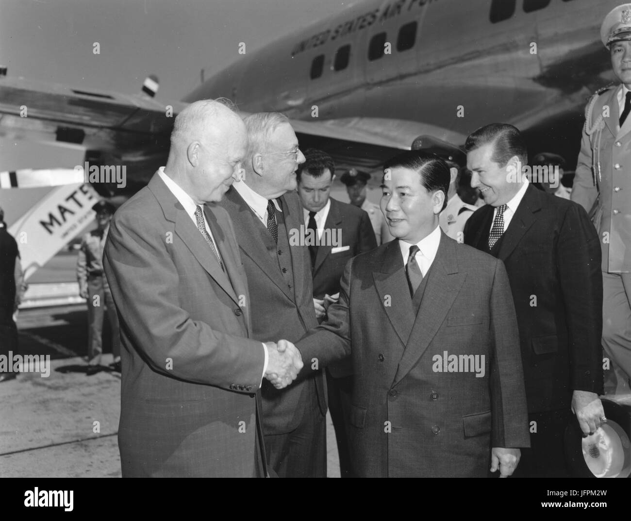President Dwight D. Eisenhower and Secretary of State John Foster Dulles greet South Vietnam's president Ngo Dinh Diem at Washington National Airport. May 8, 1957 Stock Photo