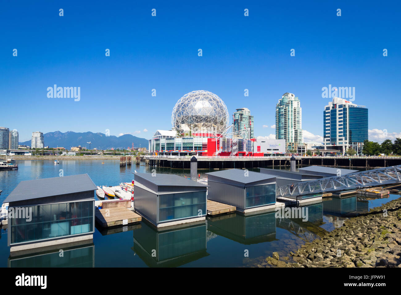 Science World at Telus World of Science (background) and the Dragon Zone Paddling Club (foreground) on False Creek in Vancouver, BC, Canada. Stock Photo