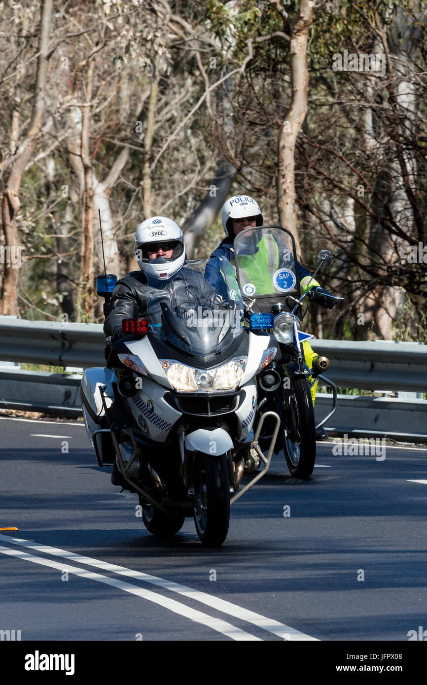 South Australian Police officer riding a BWM Police motorcycle on country roads near the town of Birdwood, South Australia. Stock Photo
