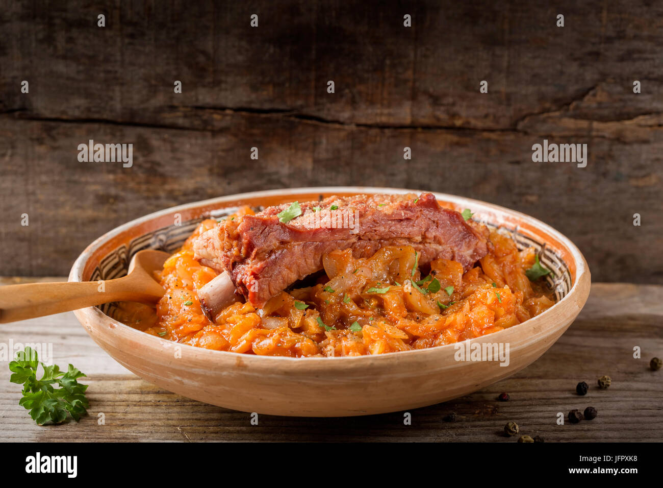Cabbage cooked with Smoked Pork Ribs with spices Served in rustic plate with copy space Stock Photo