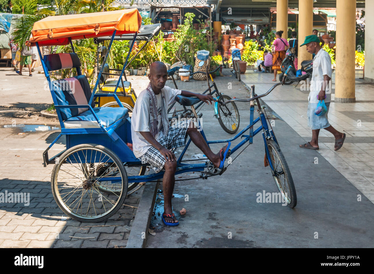 Toamasina, Madagascar - December 22, 2017:  Malagasy Man, trishaw, is resting while waiting for customers in Toamasina (Tamatave), Madagascar, East Af Stock Photo