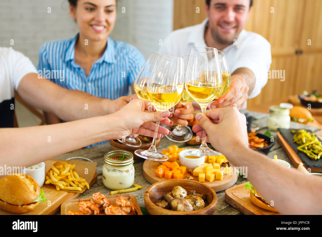 Group toasting over dinner hi-res stock photography and images - Alamy