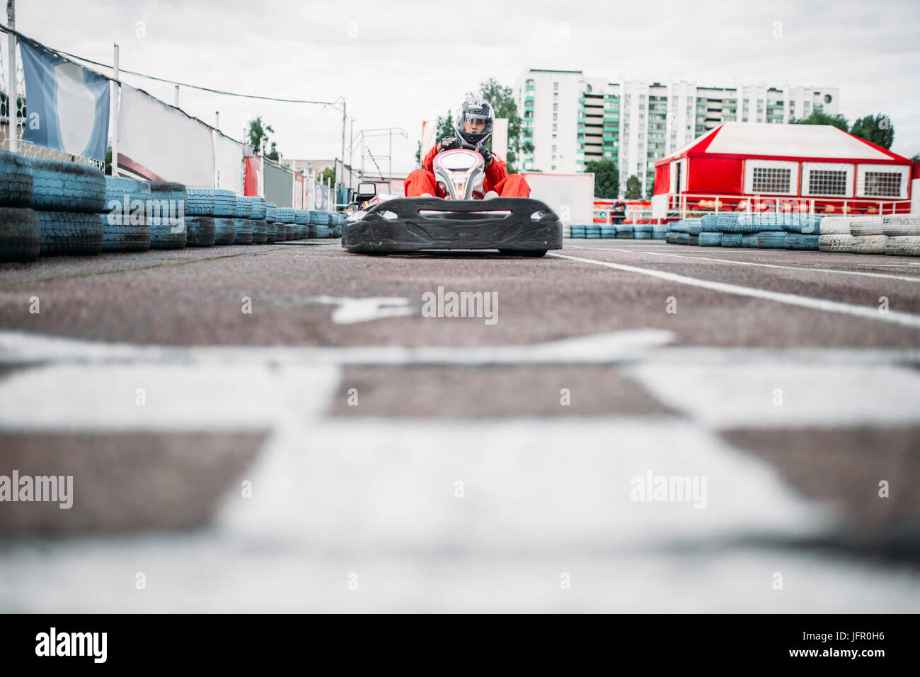 Karting racer on finish line, go kart competition. Carting championship