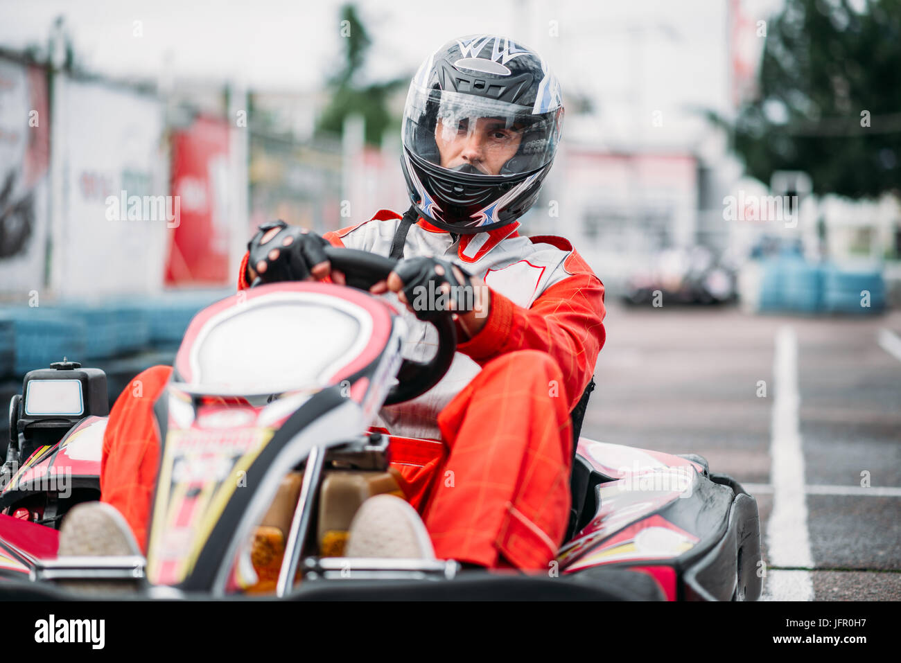 Karting racer in action, go kart competition on outdoor track. Carting