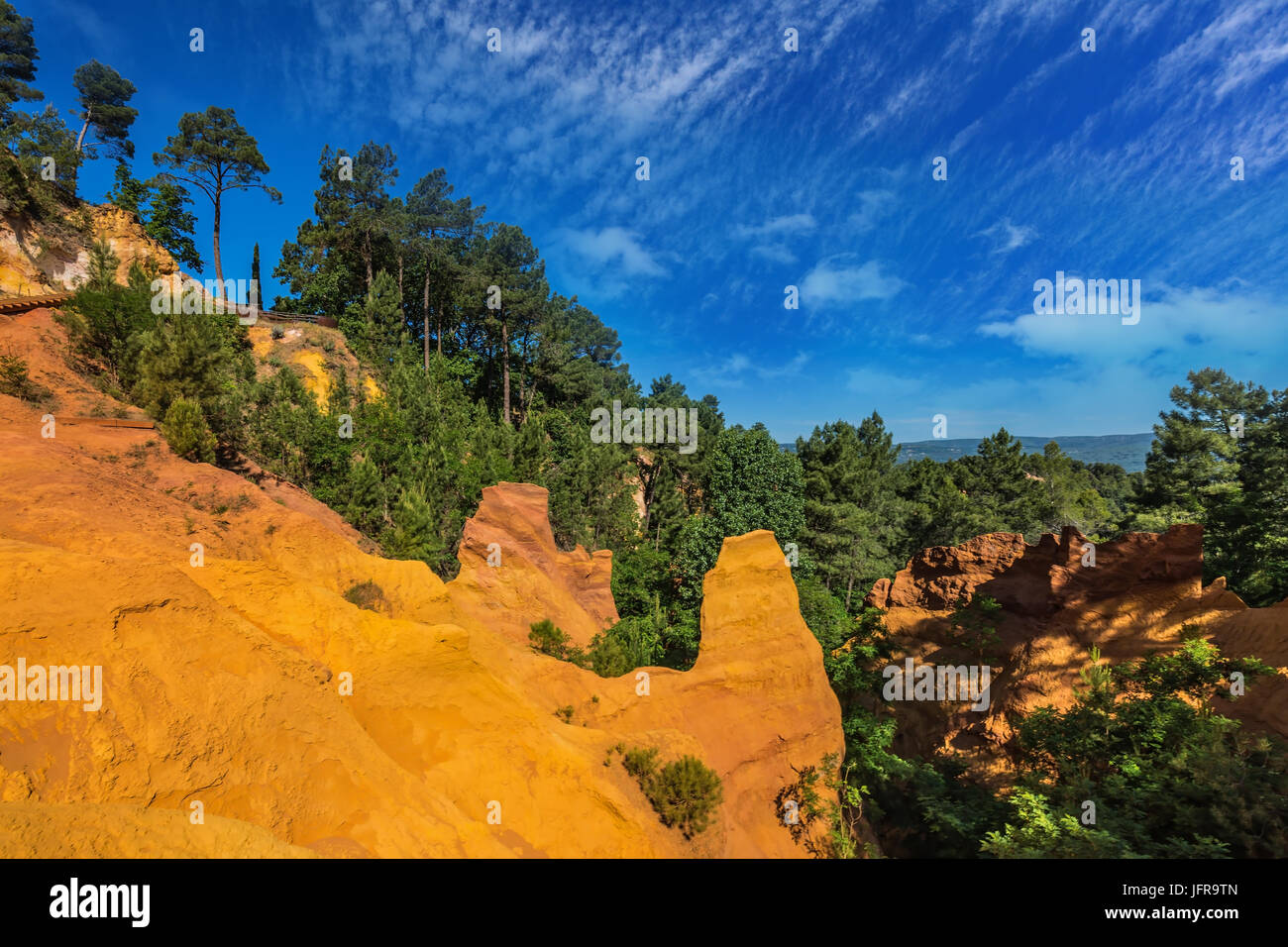 Green trees create contrast with the ocher Stock Photo - Alamy
