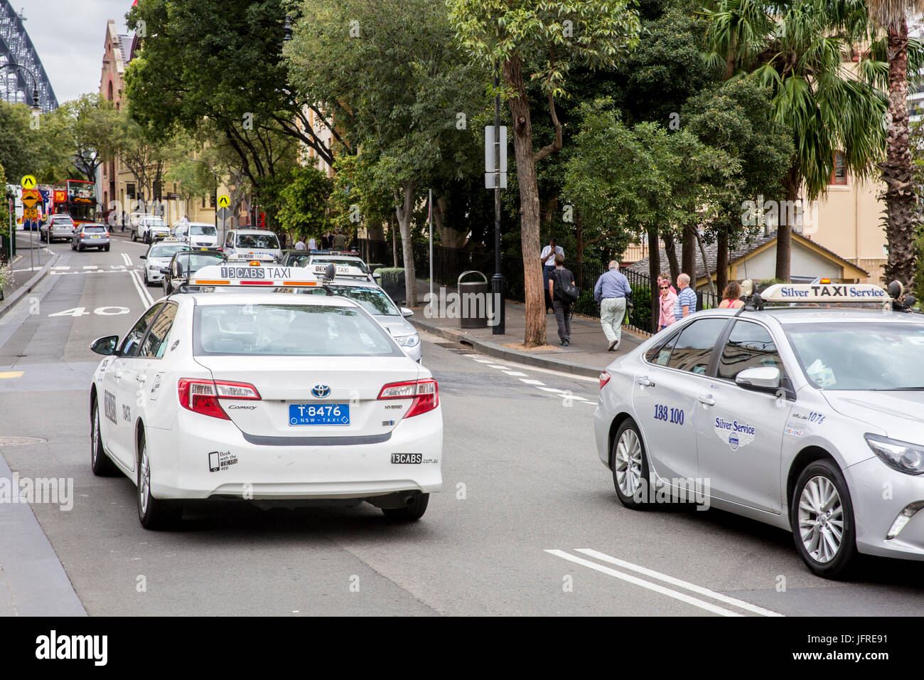 Sydney taxis travelling along street in Sydney city centre