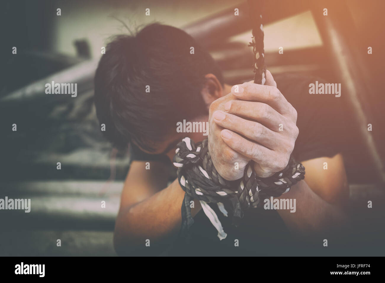 human trafficking, hands tied together with rope Stock Photo