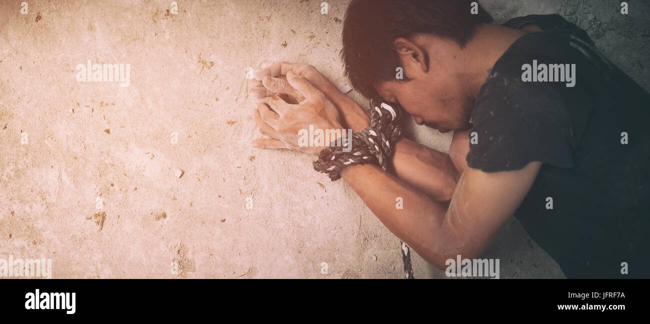 human trafficking, hands tied together with rope Stock Photo