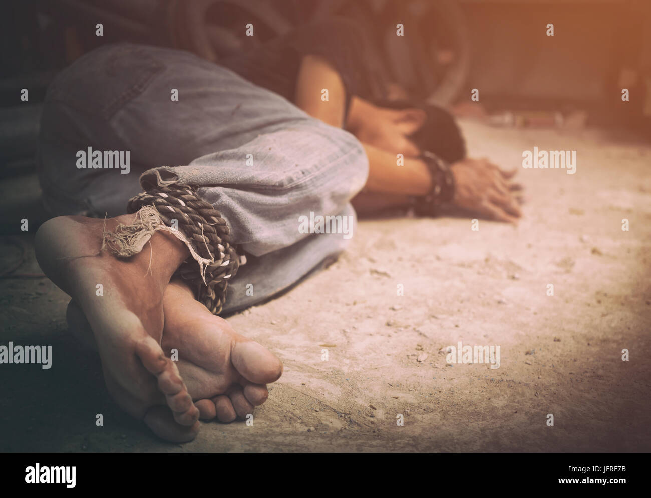 human trafficking, hands tied together with rope Stock Photo