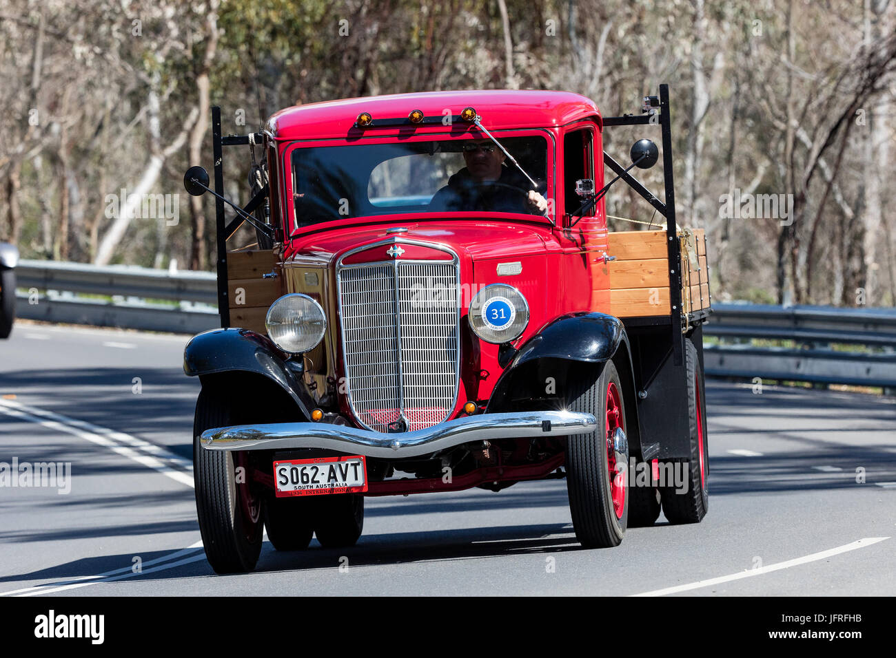 Vintage International Flat bed truck driving on country roads near the town of Birdwood, South Australia. Stock Photo