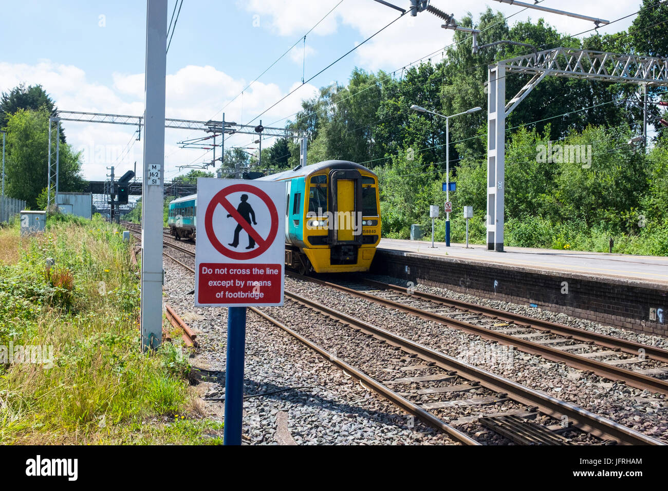 Passengers must not cross railway line warning sign at Sandbach train station Cheshire UK Stock Photo