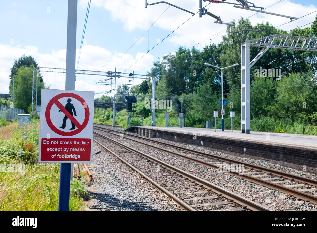 Passengers must not cross railway line warning sign at Sandbach train station Cheshire UK Stock Photo