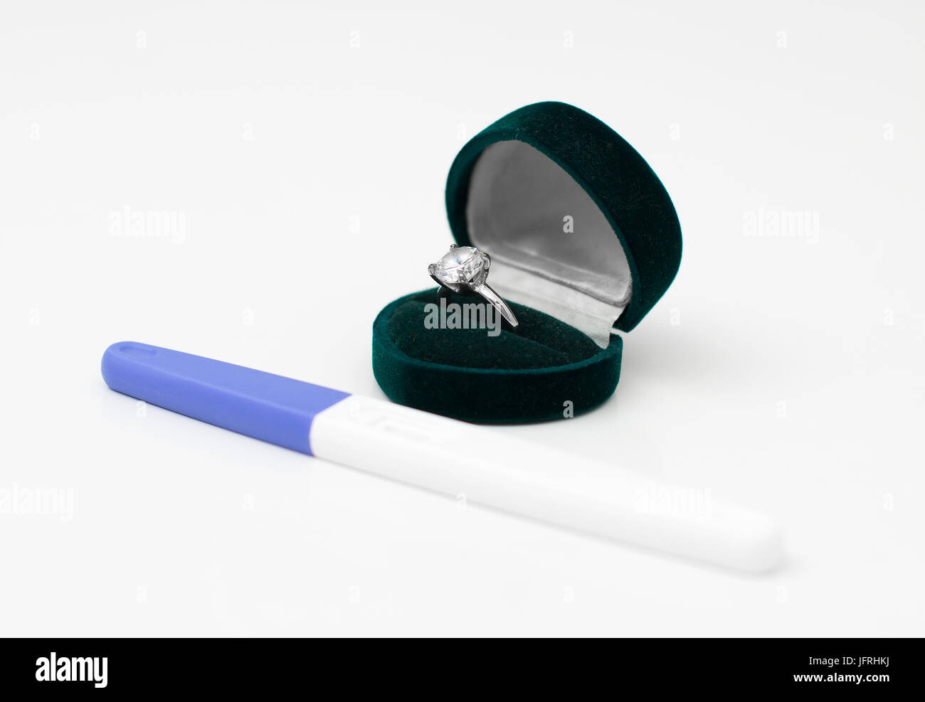Plastic pregnancy test and wedding ring for her Stock Photo Alamy