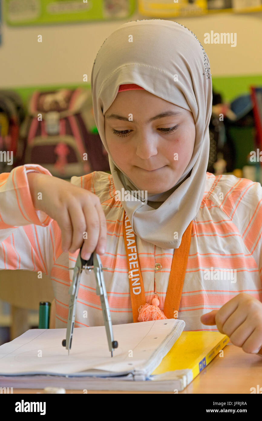 primary school girl working with her compasses Stock Photo - Alamy
