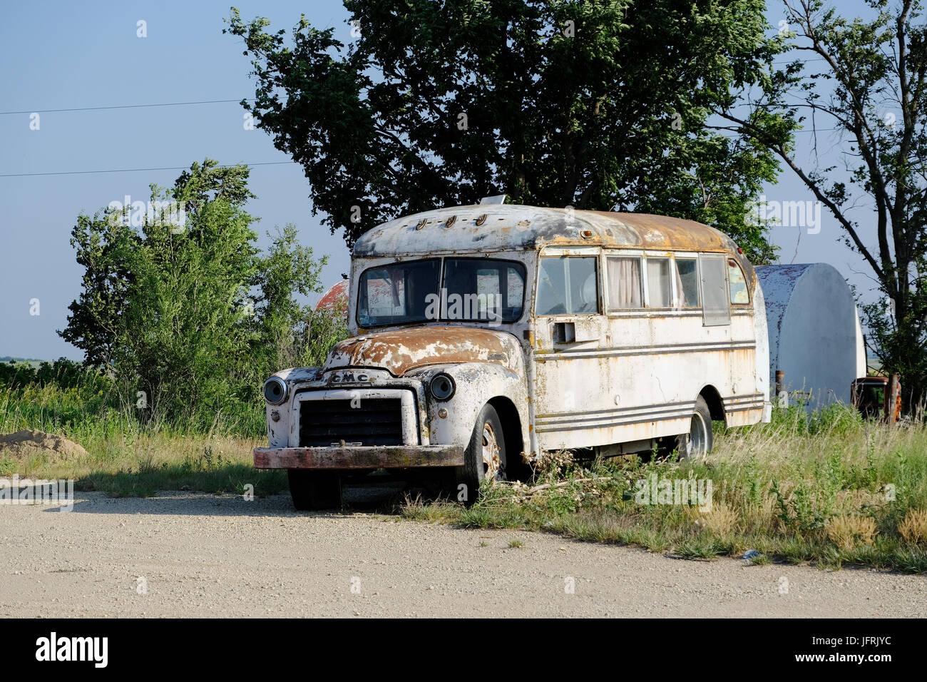 Old GMC bus converted into an RV camper sits abandoned in rural Kansas. Stock Photo