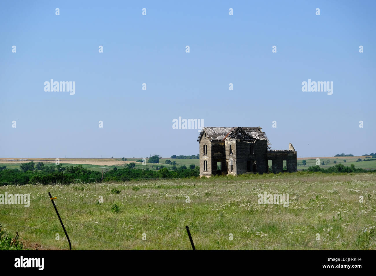 Abandoned farmstead in rural Kansas is left to decay in the elements. Stock Photo