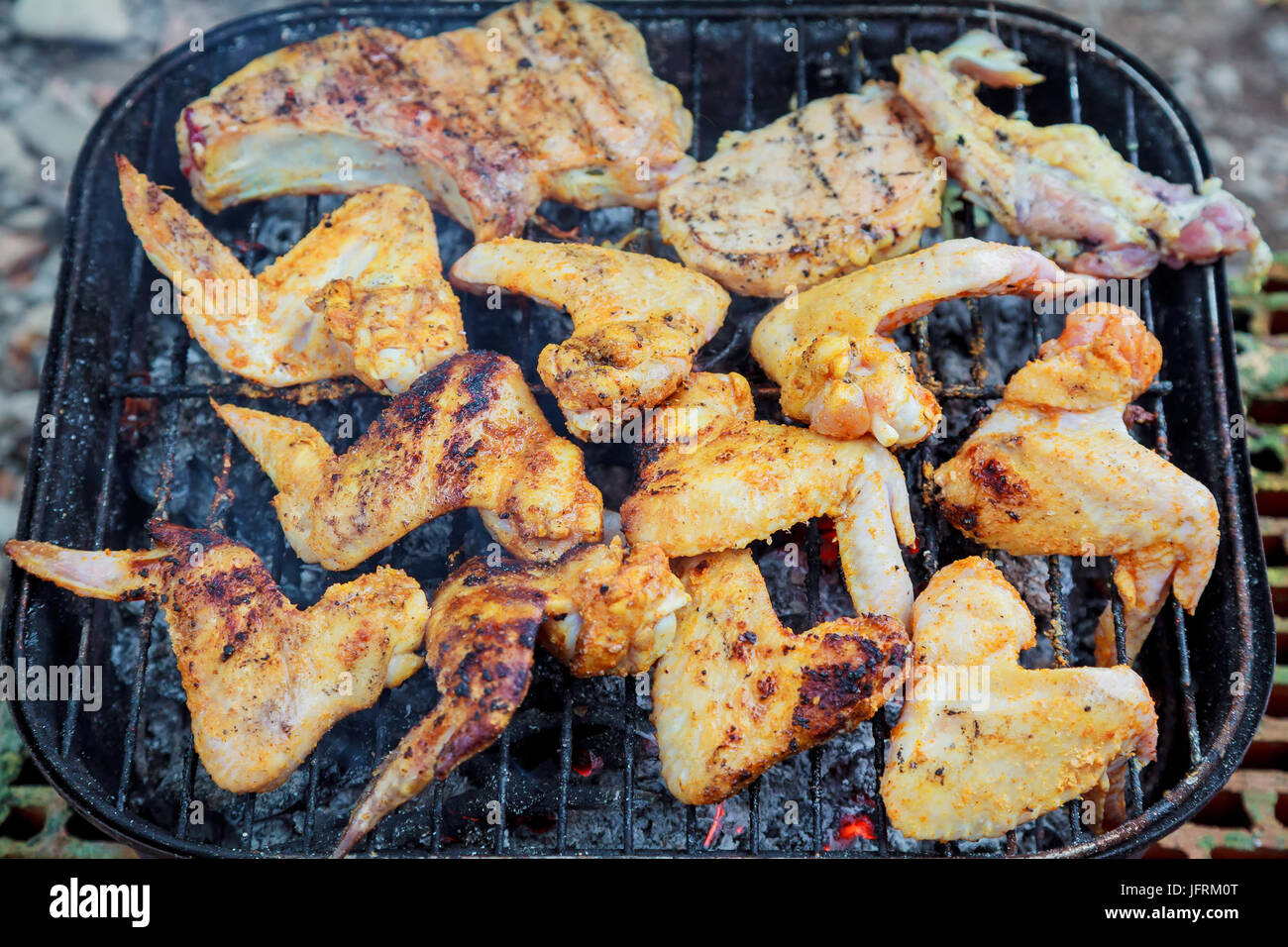 Grilling chicken wings on barbecue grill. Chicken wings on the grill