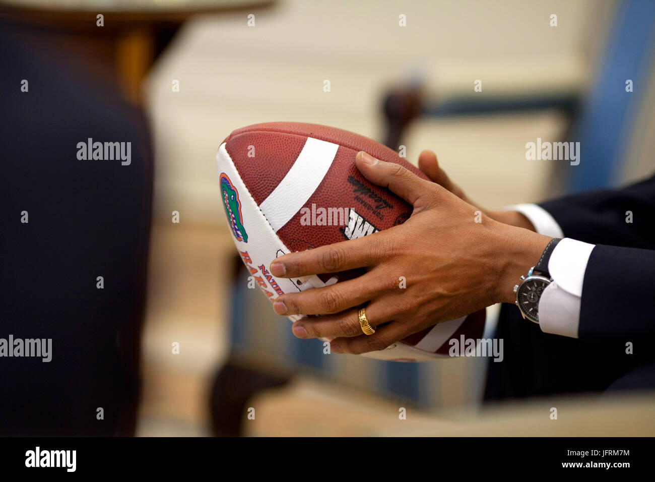 President Barack Obama holds a football during an Oval Office briefing for an upcoming healthcare meeting  May 11, 2009. Official White House Photo by Pete Souza.  This official White House photograph is being made available for publication by news organizations and/or for personal use printing by the subject(s) of the photograph. The photograph may not be manipulated or used in materials, advertisements, products, or promotions that in any way suggest approval or endorsement of the President, the First Family, or the White House. Stock Photo