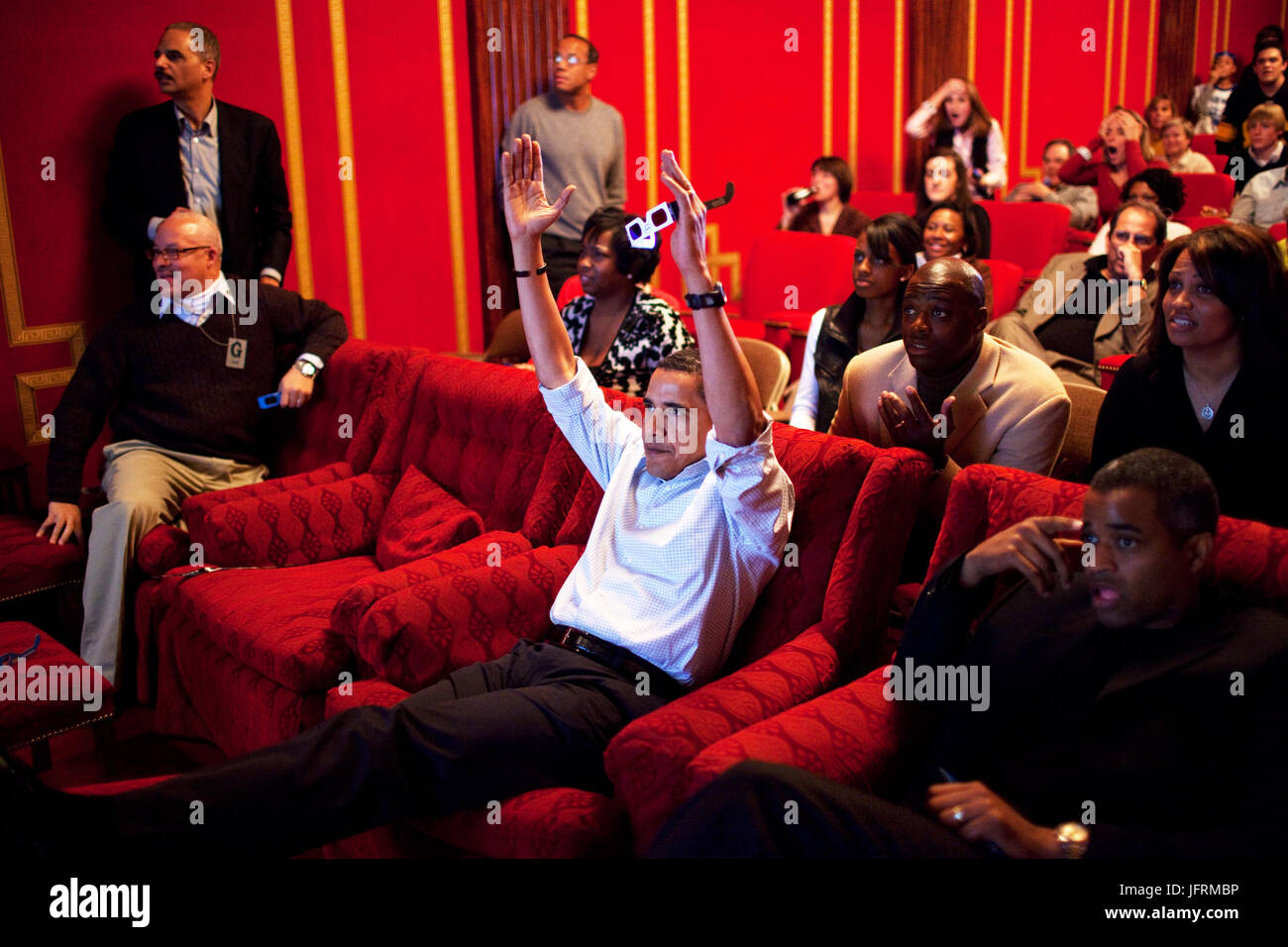President Barack Obama holds 3-D glasses while watching the Super Bowl game at a Super Bowl Party in the family theater of the White House. Guests included family, friends, staff members and bipartisan members of Congress, 2/1/09.  Official White House Photo by Pete Souza Stock Photo