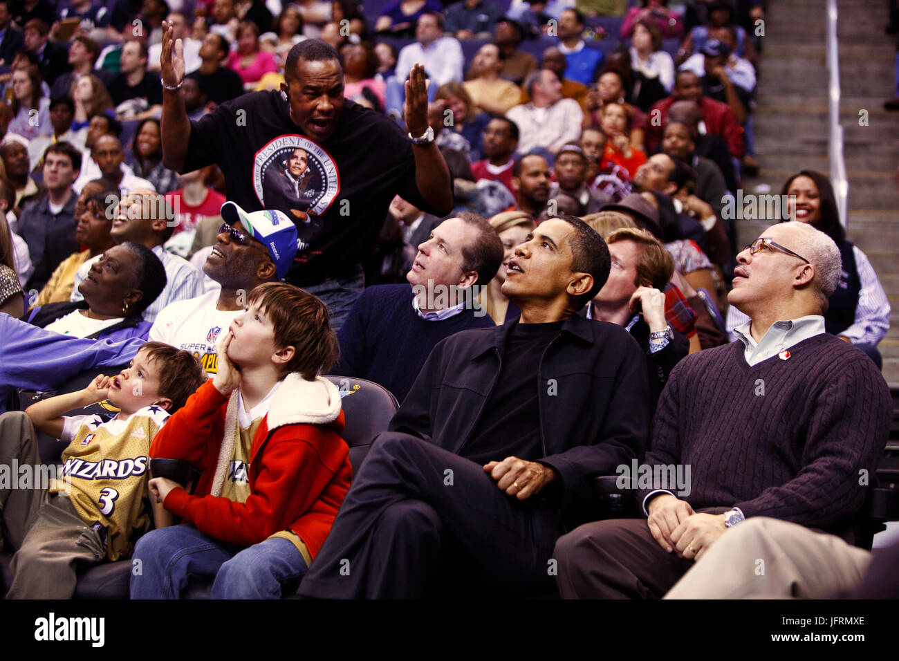 President Barack Obama attends a Washington Wizards vs Chicago Bulls basketball game at the Verizon Center, Washington, D.C 2/27/09.  Official White House Photo by Pete Souza Stock Photo