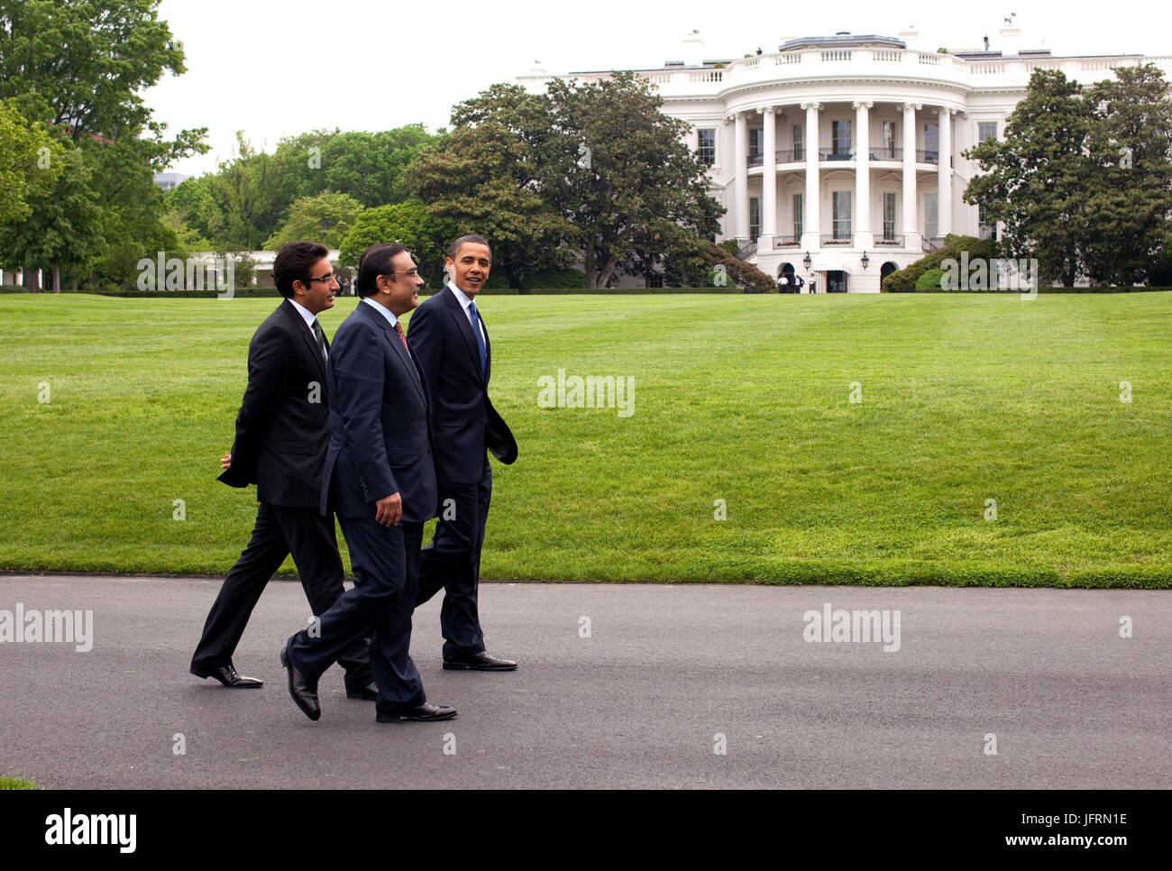 President Obama and Pakistan President Asif Ali Zardari walk around the South Lawn of the White House prior to US-Afghan-PakistanTrilateral meeting  May 6, 2009.  This official White House photograph is being made available for publication by news organizations and/or for personal use printing by the subject(s) of the photograph. The photograph may not be manipulated in any way or used in materials, advertisements, products, or promotions that in any way suggest approval or endorsement of the President, the First Family, or the White House. Stock Photo