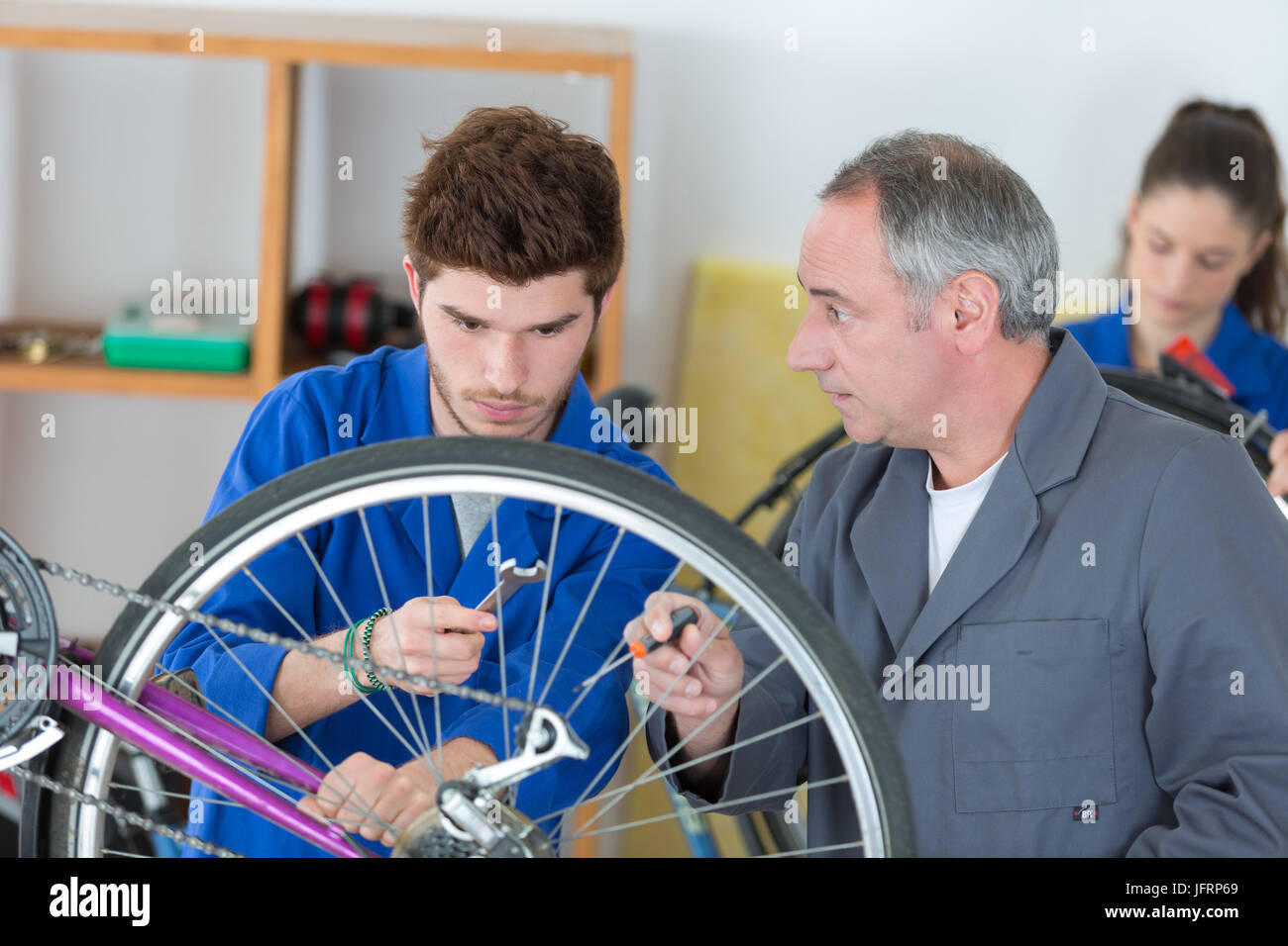 bicycle mechanic mounting brake caliper on bike Stock Photo Alamy