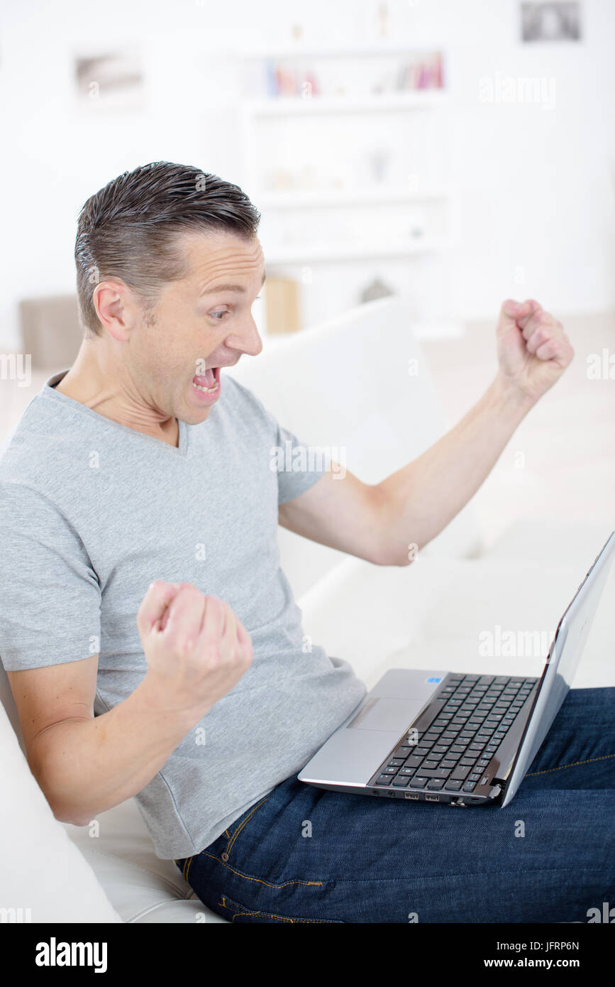 happy man completed task and triumphing with raised hands Stock Photo ...