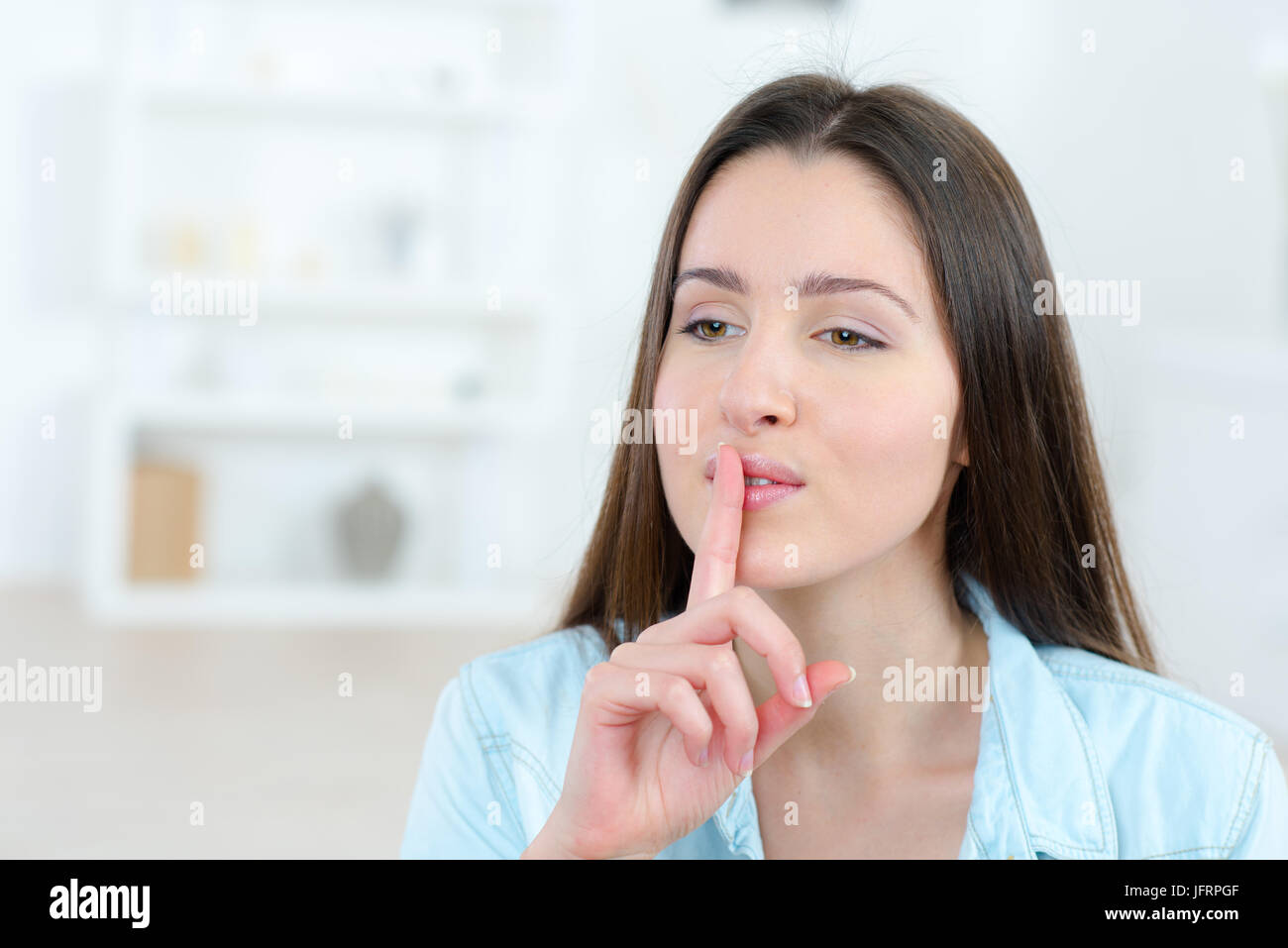 female nurse placing finger on lips Stock Photo Alamy