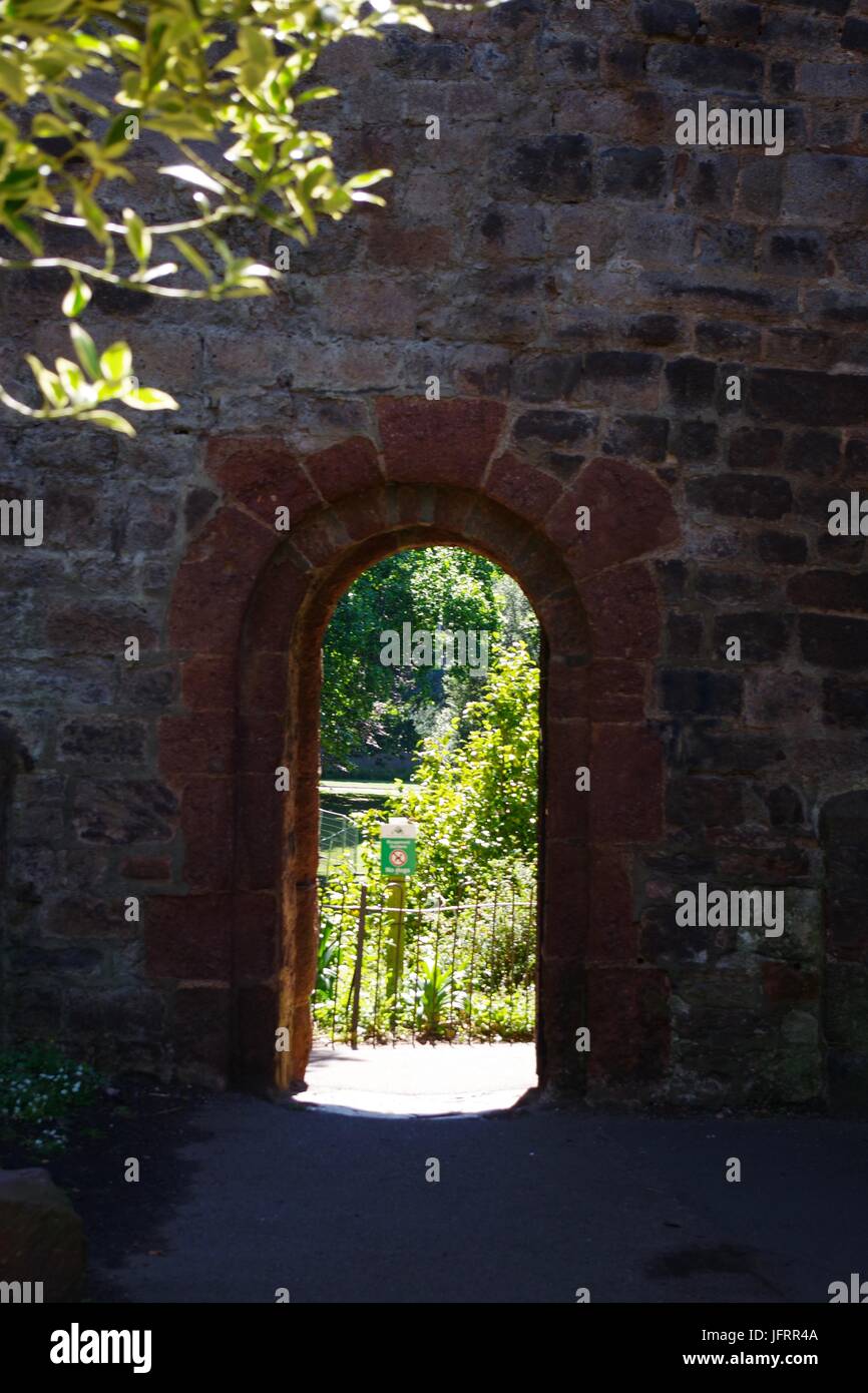 Arched Gateway Through the Curtain Wall of Rougemont Castle in Northernhay Garden. Exeter, Devon, UK. July, 2017. Stock Photo