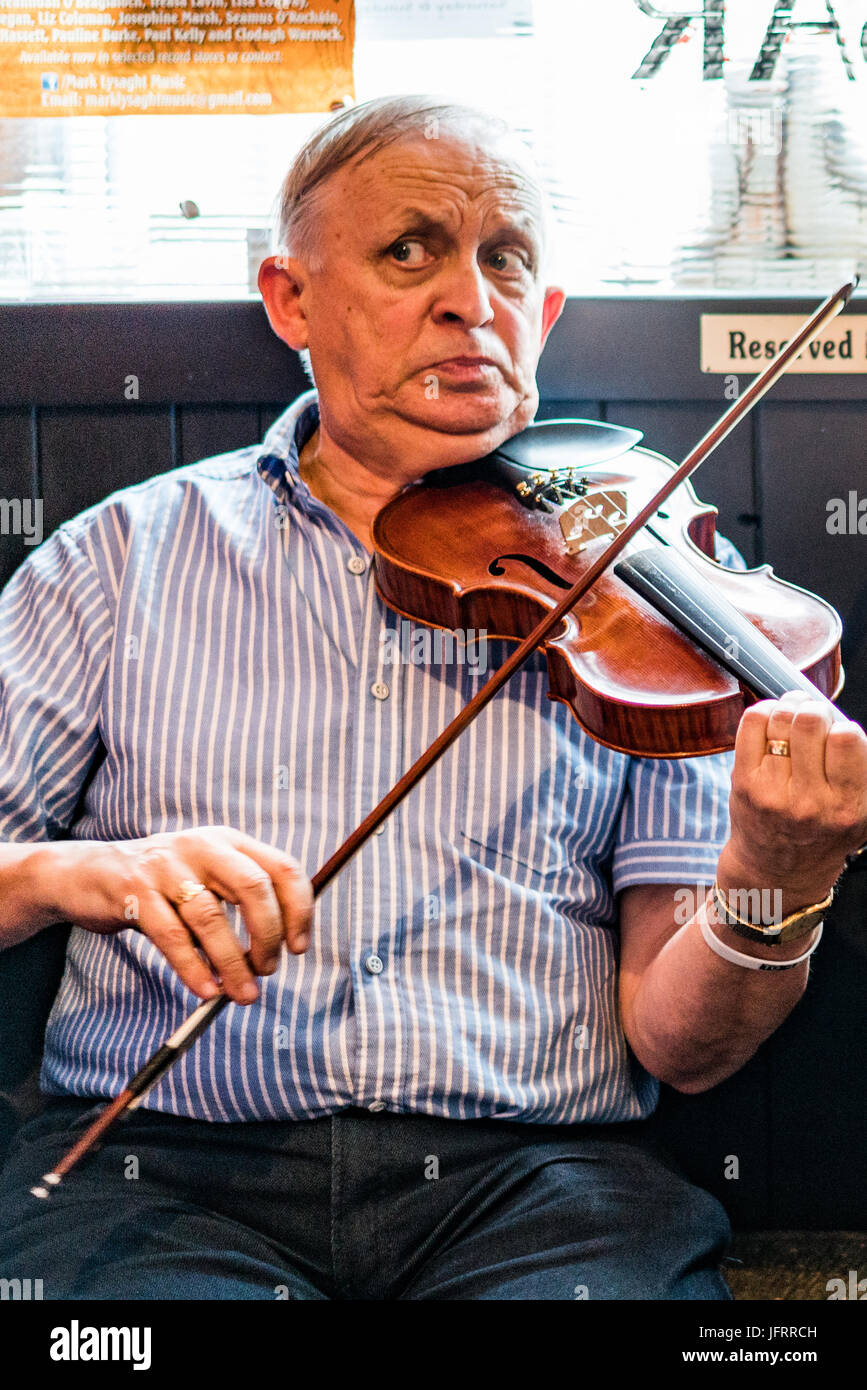 A fiddle player at a traditional music session at a pub in Dublin