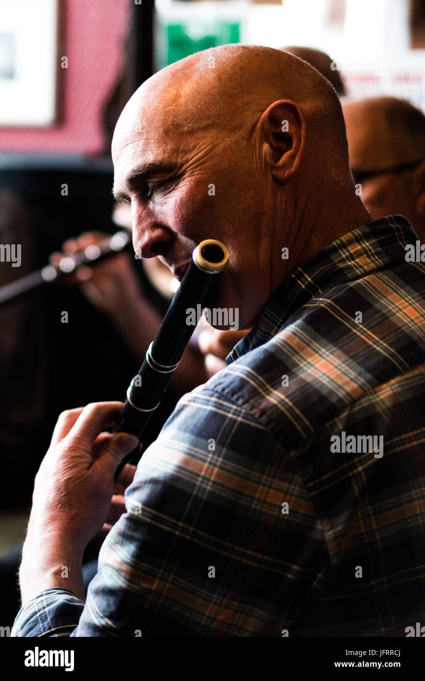 A flute player at an Irish traditional session music at a pub in Dublin, Ireland Stock Photo