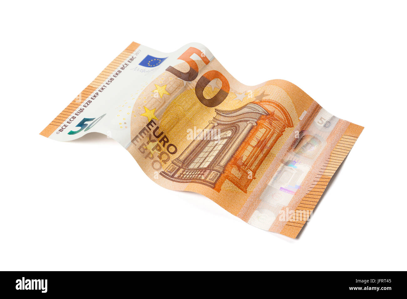 New Fifty Euros bill issued in 2017 laid in wave shape isolated with clipping path on white background Stock Photo