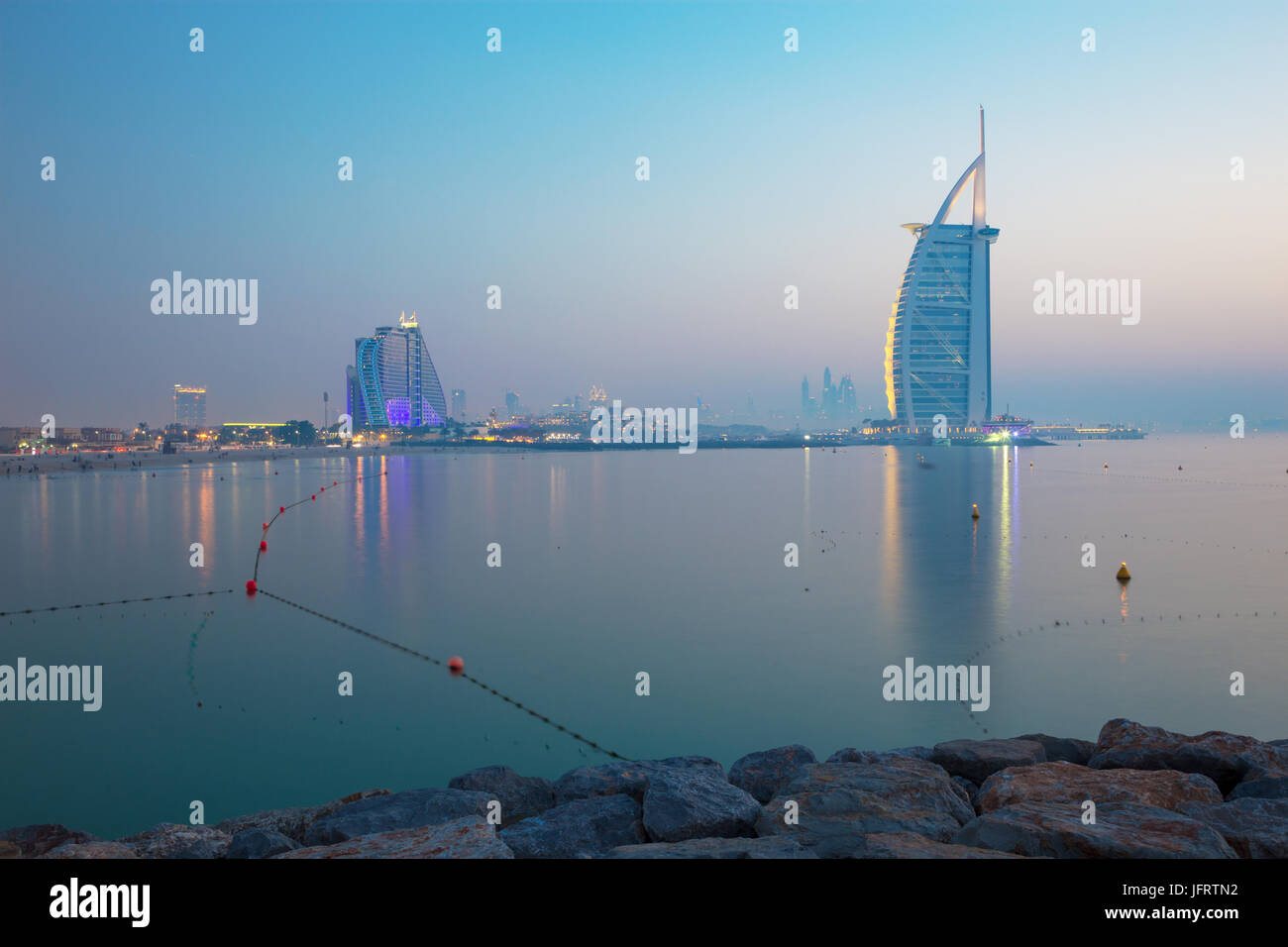 DUBAI, UAE - MARCH 30, 2017: The evening skyline with the Burj al Arab and Jumeirah Beach Hotels and the open Jumeriah beach. Stock Photo