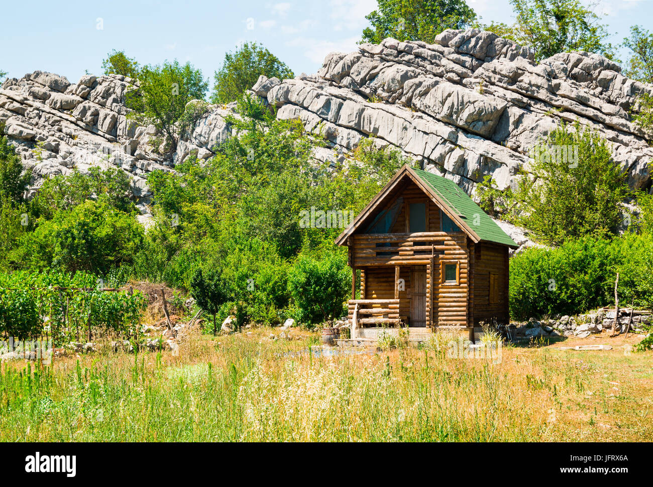 Small wooden house next to rocks Stock Photo - Alamy