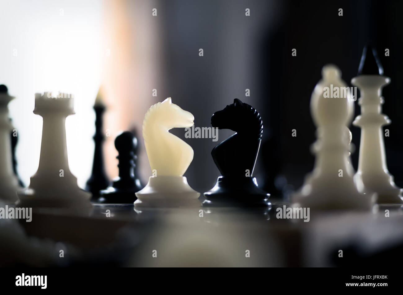 black and white chess on chessboard. white chess victory again black Stock Photo