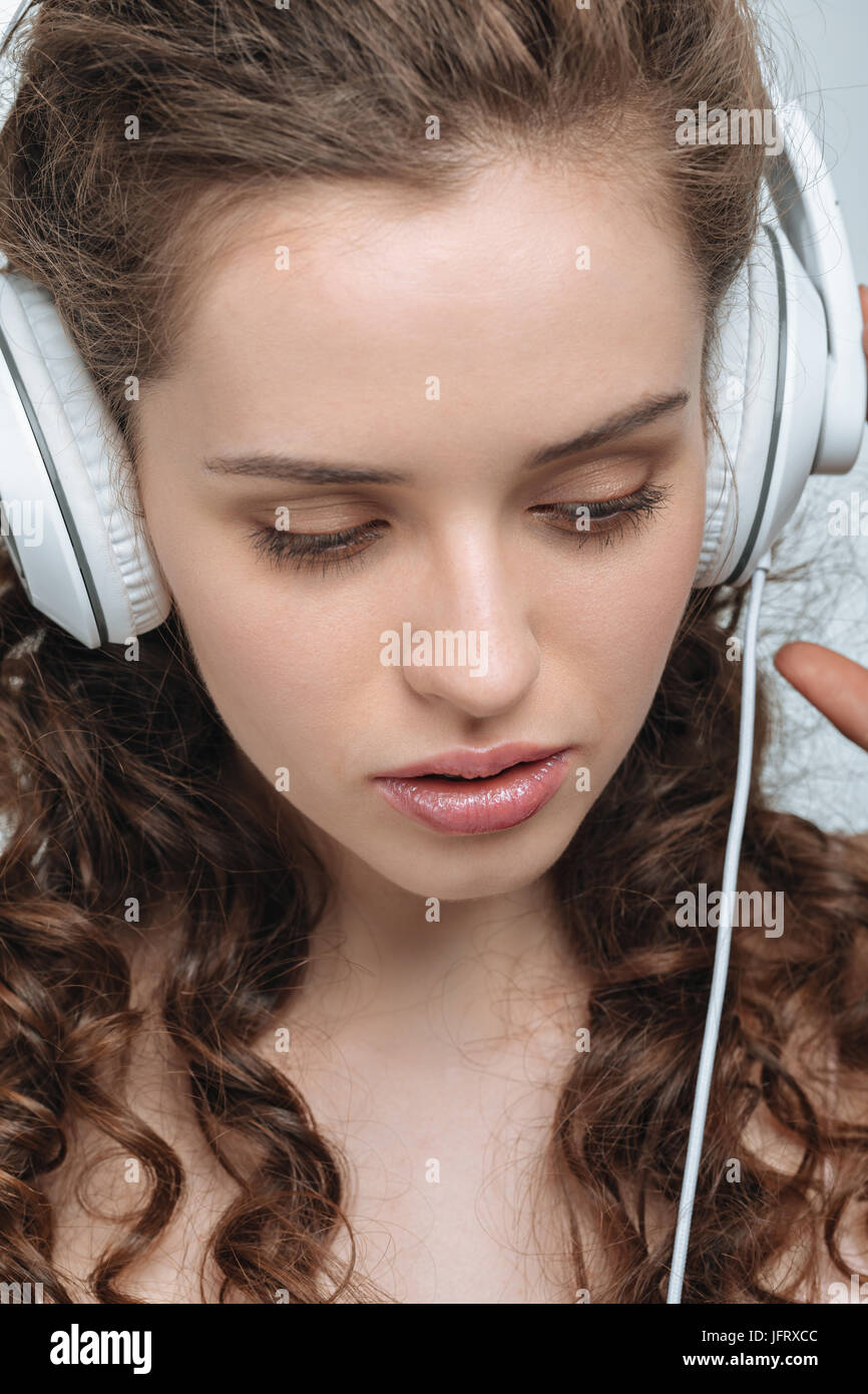 portrait of attractive young woman listening music in headphones Stock ...