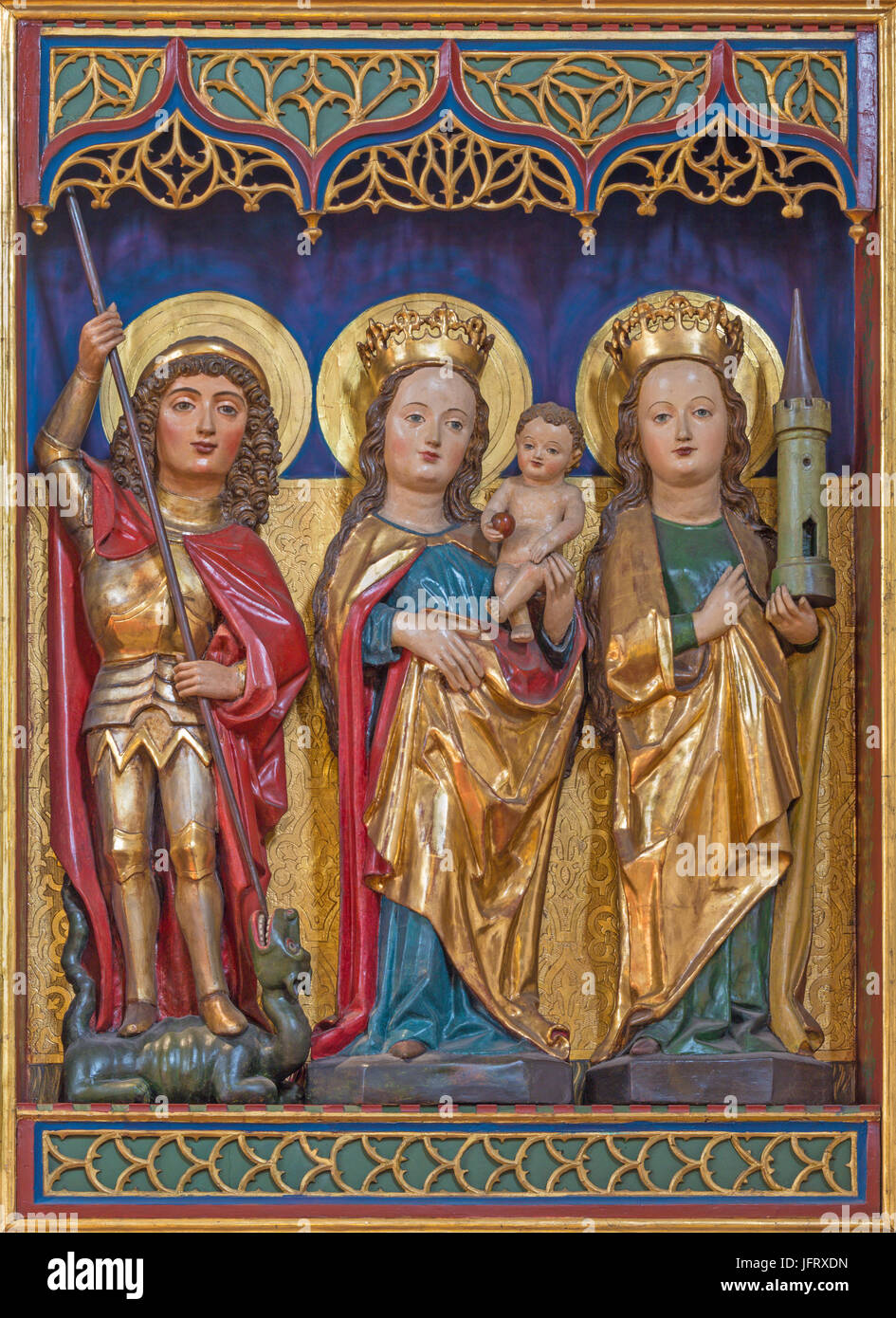 BERLIN, GERMANY, FEBRUARY - 16, 2017: The carved polychrome gothic altar with the Madonna, St. Barbara and St. George in  Dominicans church of St. Pau Stock Photo