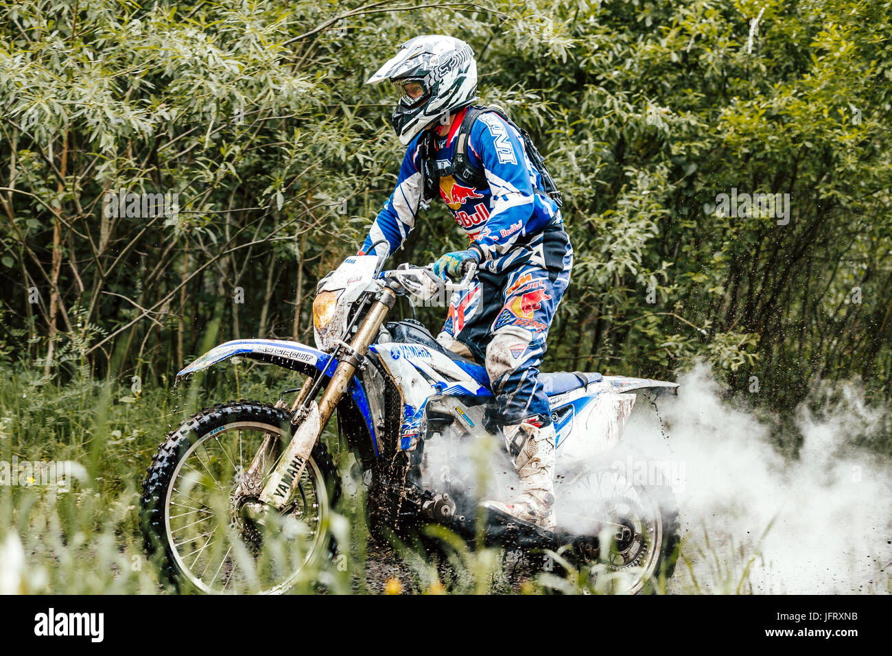 motorcycle rider in forest of exhaust gas back during Ural Cup in Enduro Stock Photo