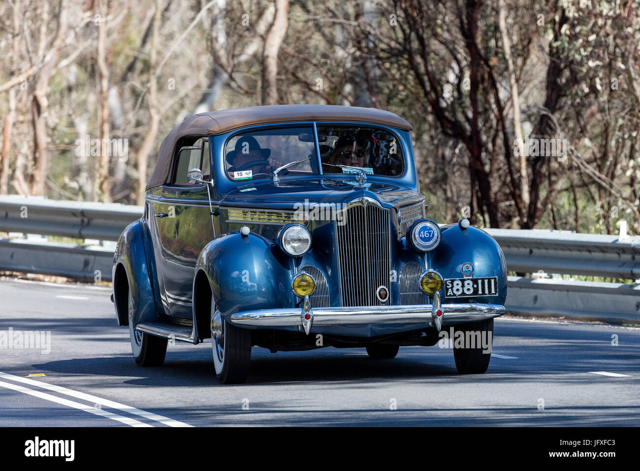 Vintage 1940 Packard 110 Convertible Coupe driving on country roads near the town of Birdwood, South Australia. Stock Photo